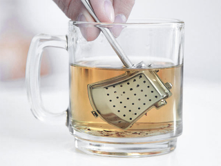 Illustration for article titled An Axe-Shaped Tea Strainer, Because Even Lumberjacks Need a Break